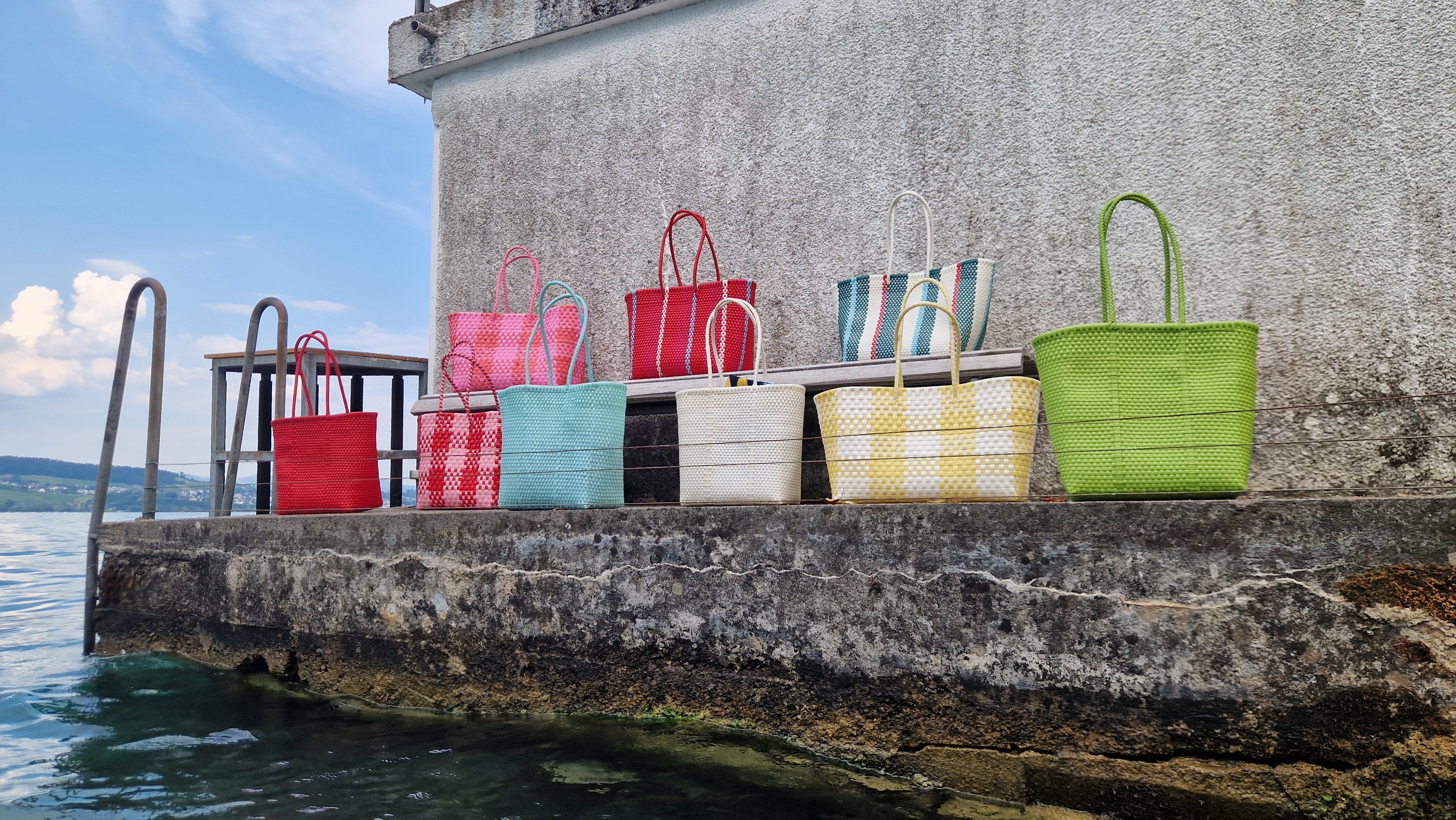 Alma Tote Chica in Grün — handgeflochtene Tragetasche aus recyceltem Kunststoff, kompakte Grösse mit langen Henkeln